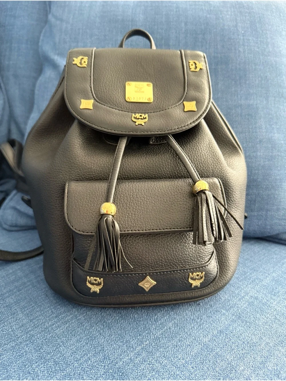 MCM Black Leather Drawstring Backpack with Gold Accents